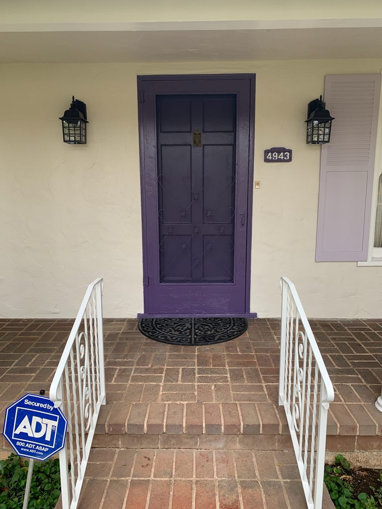 Purple door on an enhanced entry